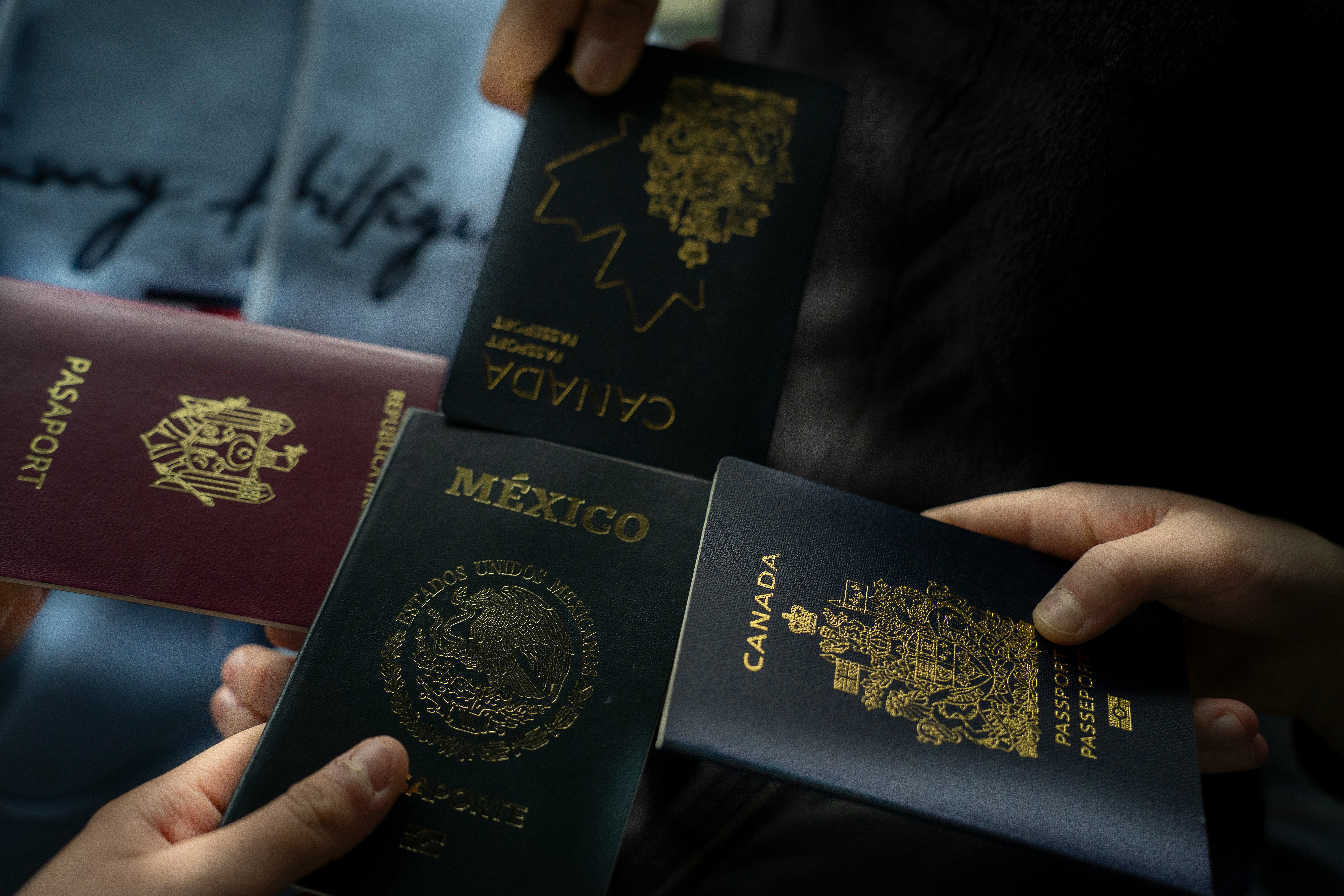 Several passports held together for a family immigration journey