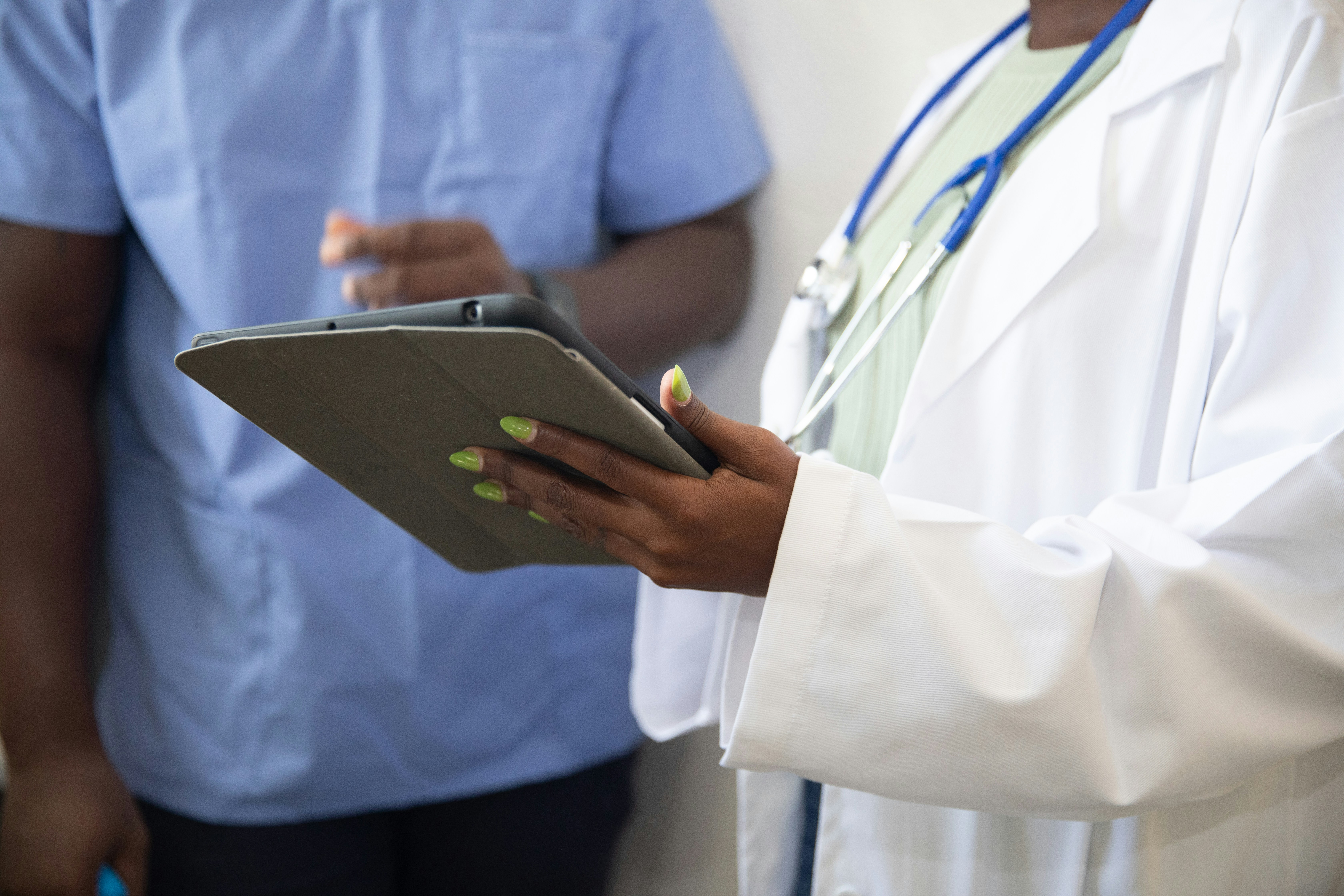 Medical professional reviewing information on a tablet