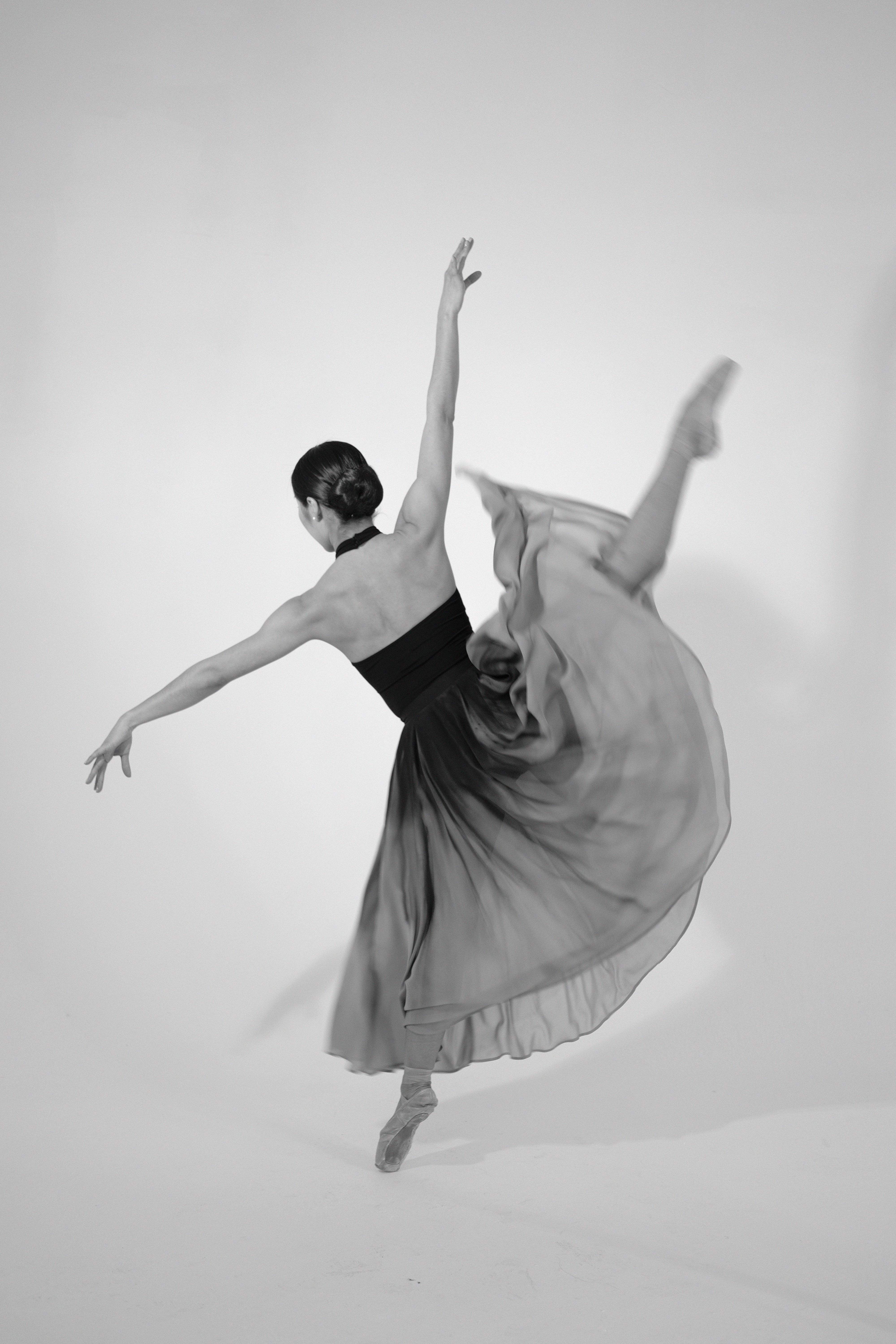 Ballet dancer performing a poised movement in a studio