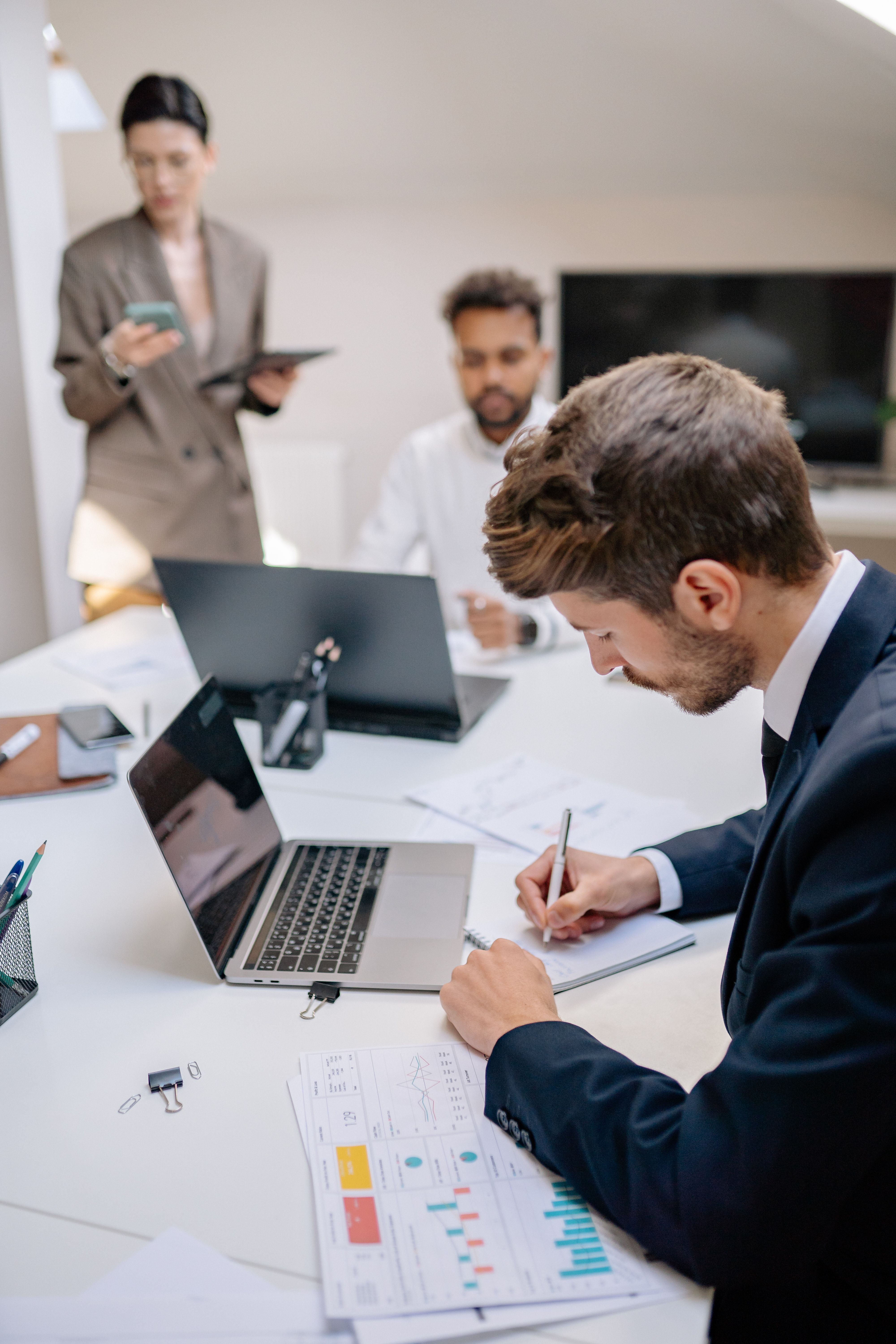 Professionals reviewing business documents at a meeting